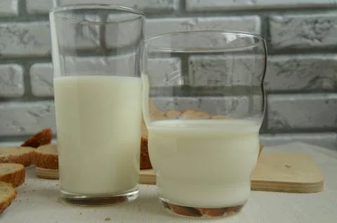 Two glasses of milk are on the table, Breakfast for the family, healthy eating Stock Photos