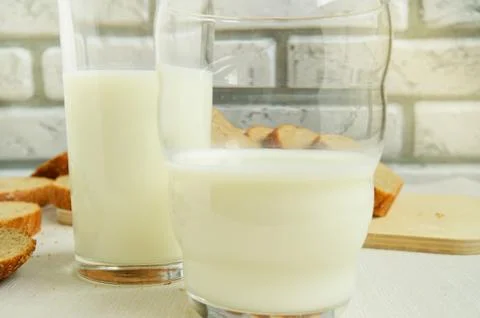 Two glasses of milk are on the table, Breakfast for the family, healthy eatin Stock Photos
