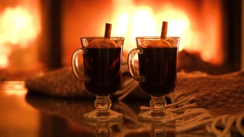 Two glasses with mulled wine and plaid on the fireplace background. Stock Footage 166395578