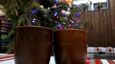 Two glasses of mulled wine on the background of Christmas garland and colorful l Stock Footage 101376184