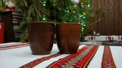 Two glasses of mulled wine on the background of Christmas garland and colorful l Stock Footage 101376220