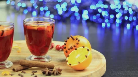 Two glasses of mulled wine close-up with apple orange and cinnamon Video stock 145829564