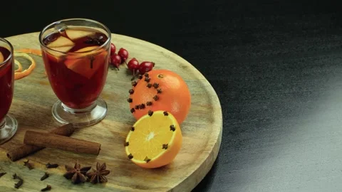 Two glasses of mulled wine close-up with apple orange and cinnamon Video stock 145829735