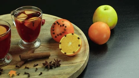 Two glasses of mulled wine close-up with apple orange and cinnamon Video stock 145829756