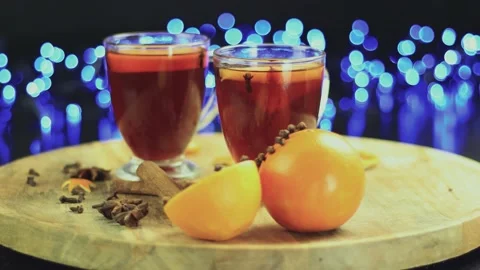 Two glasses of mulled wine close-up with apple orange and cinnamon Video stock 145829828