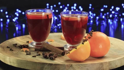 Two glasses of mulled wine close-up with apple orange and cinnamon Video stock 145829852