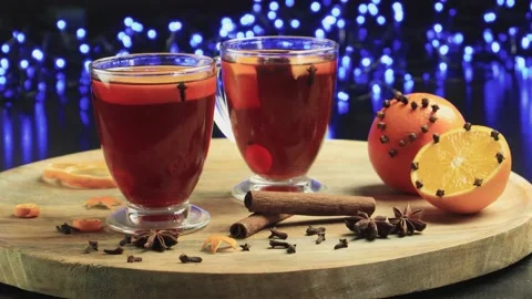 Two glasses of mulled wine close-up with apple orange and cinnamon Video stock 145829872