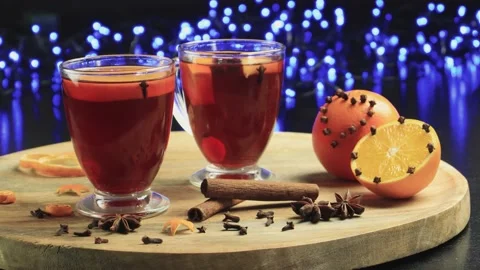 Two glasses of mulled wine close-up with apple orange and cinnamon Video stock 145829877