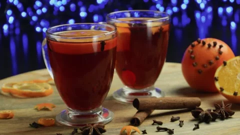 Two glasses of mulled wine close-up with apple orange and cinnamon Video stock 145829905