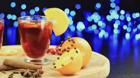 Two glasses of mulled wine close-up with apple orange and cinnamon Video stock 145830088