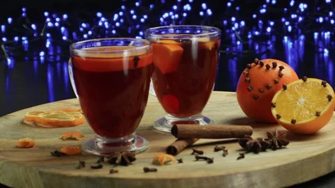 Two glasses of mulled wine close-up with apple orange and cinnamon Video stock 145830092
