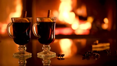 Two glasses with mulled wine on the fireplace background. Stockbeeldmateriaal 166394598