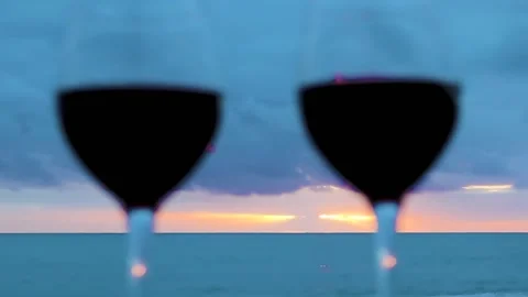 Two Glasses on the Ocean Beach. Glasses with Red Wine for a Romantic Date, Sea. Stock Footage 231141774