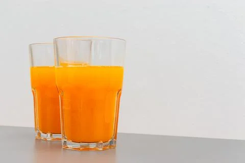 Two glasses of orange juice on the table with copy space Stock Photos