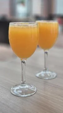 Two Glasses of Orange Juice on a Table Photos