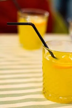 Two glasses with orange lemonade on the table in a cafe. Stock Photos