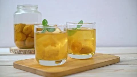 Two glasses of peach iced tea with mint on wooden tray Stock Photos