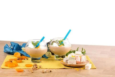 Two glasses of peach smoothie with fruit and marshmallows Stock Photos