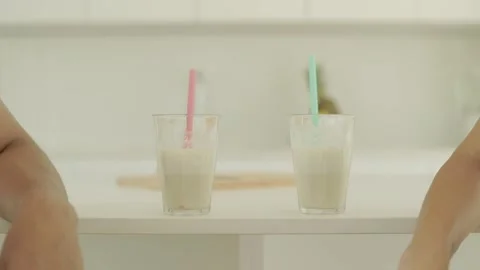Two glasses of protein shakes sit on the kitchen counter. Video stock 244733350