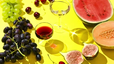 Two glasses of red and white wine. A woman pours wine from a bottle. Grapes and Video stock 152055939