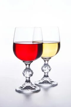 Two Glasses of red and white wine on light background. Stock Photos