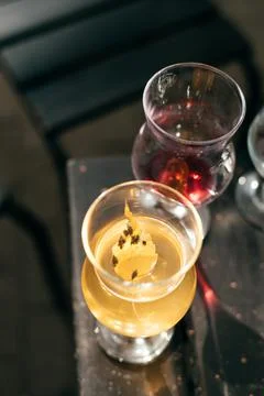 Two glasses of red and white wine on a wooden table Stock Photos