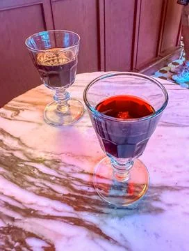 Two glasses with red cherry drink in cafe Stock Photos