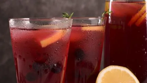 Two Glasses of Red Fruit Sangria with Thyme and Lemon Stock Photos