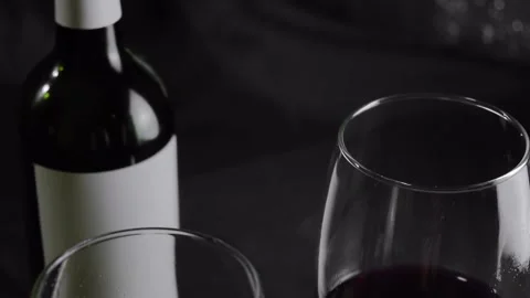 Two glasses of red wine and a bottle are on the table. Top view Vídeo Stock 146678473