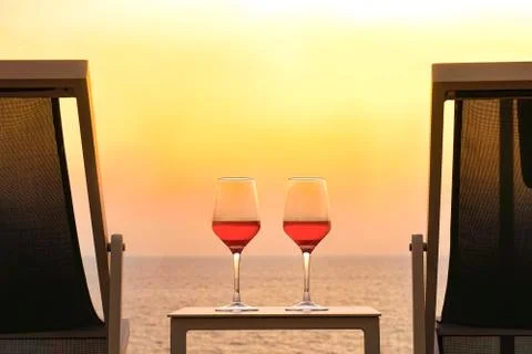Two glasses of red wine on the background of the sea. Stock Photos