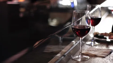 Two glasses of red wine on a bar countertop Stock Footage 104665240