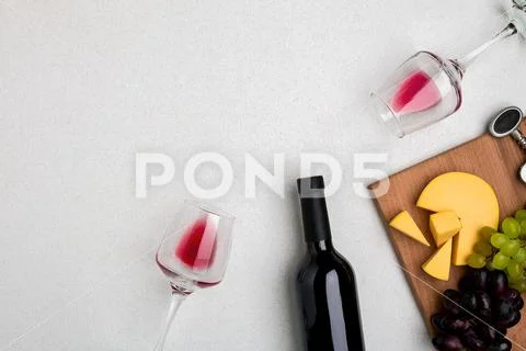 Two glasses of red wine, cheese and grapes. Top view Stock Photos
