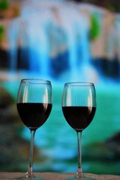 Two glasses of red wine in close-up on a beautiful turquoise background. Stock Photos
