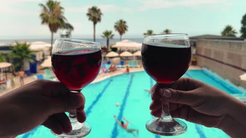 Two glasses of red wine in hands of couple against the background of the sea and Stock Footage 318006878