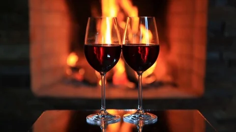 Two glasses of red wine near a fireplace Video stock 81661948