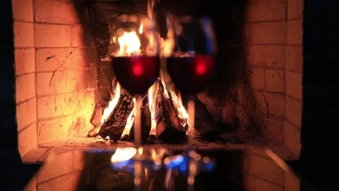 Two glasses of red wine near a fireplace 스톡 동영상 85968925