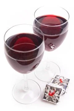 Two glasses of red wine with a small gift Stock Photos