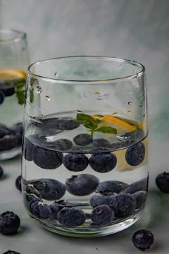 Two glasses,with a refreshing drink cold water, blueberries, lemon, mint Stock-Fotos