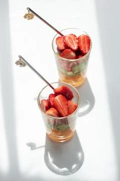 Two glasses of refreshing fruit salad preparing for consumption Stock Photos
