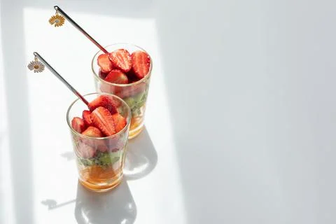 Two glasses of refreshing fruit salad with strawberries and kiwi Stock Photos