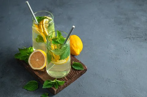 Two glasses of refreshing mint lemonade on a graphite background. Stock Photos