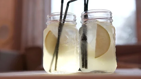 Two glasses with a refreshing pear lemonade on a summer day Stock Footage 111950357