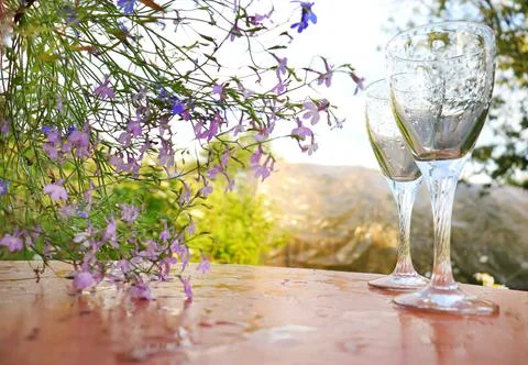 Two glasses of Roma stand on the table against the backdrop of the sunset Stock Photos
