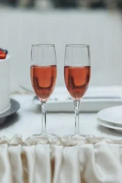 Two glasses of rose wine stand elegantly side by side Foto stock