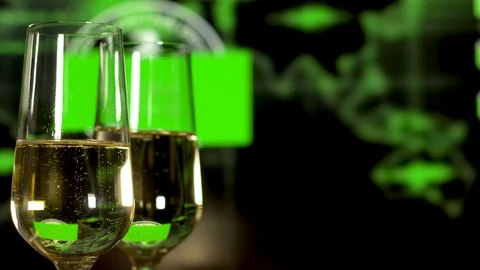 Two glasses with sparkling champagne over haker programme background. Vidéo 111443442