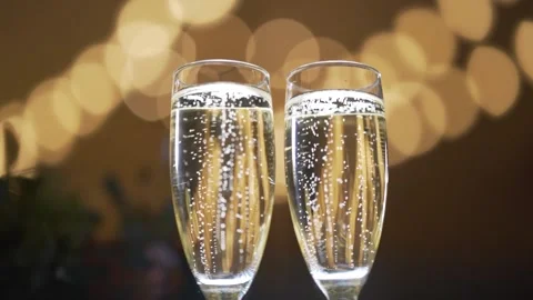 Two glasses with sparkling champaign with bubbles stand on the soft background Stock Footage 174409615