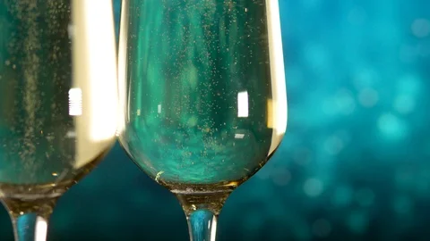 Two glasses with sparkling wine over blue background. Close up Stock Footage 111193516