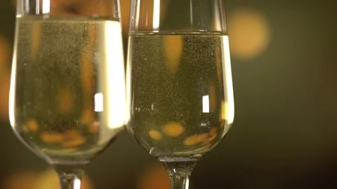 Two glasses with sparkling wine over golden background. Close up Stock Footage 111287580