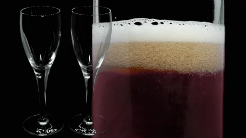 Two glasses standing next to a bottle of sparkling pink wine. Stock Footage 171386611