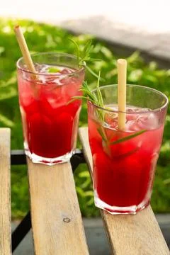 Two glasses on a table outside with red lemonade Stock Photos